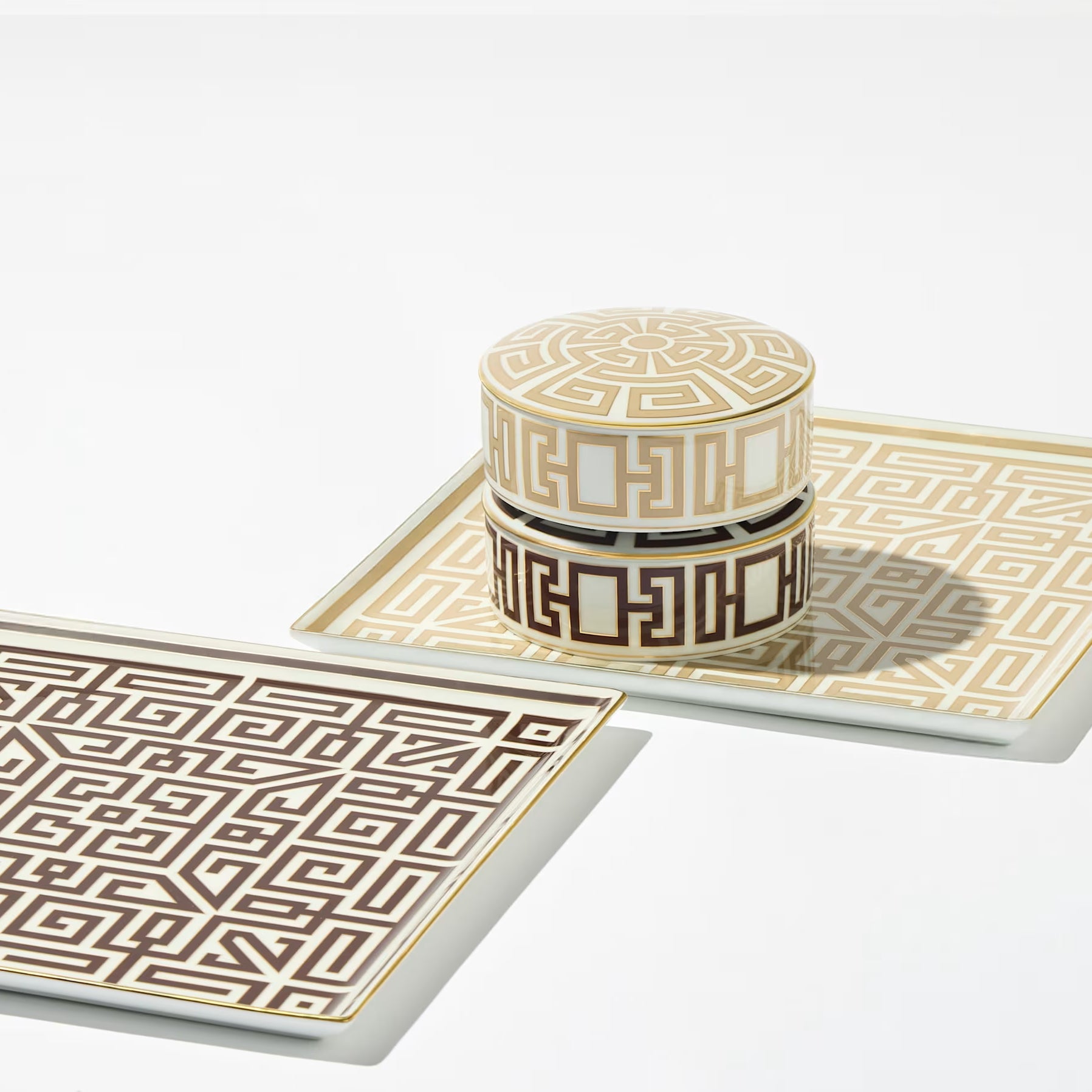 Luxury White Container With Gold Geometric Pattern. Ceramic tray with geometric pattern and matching cylindrical container on a white background