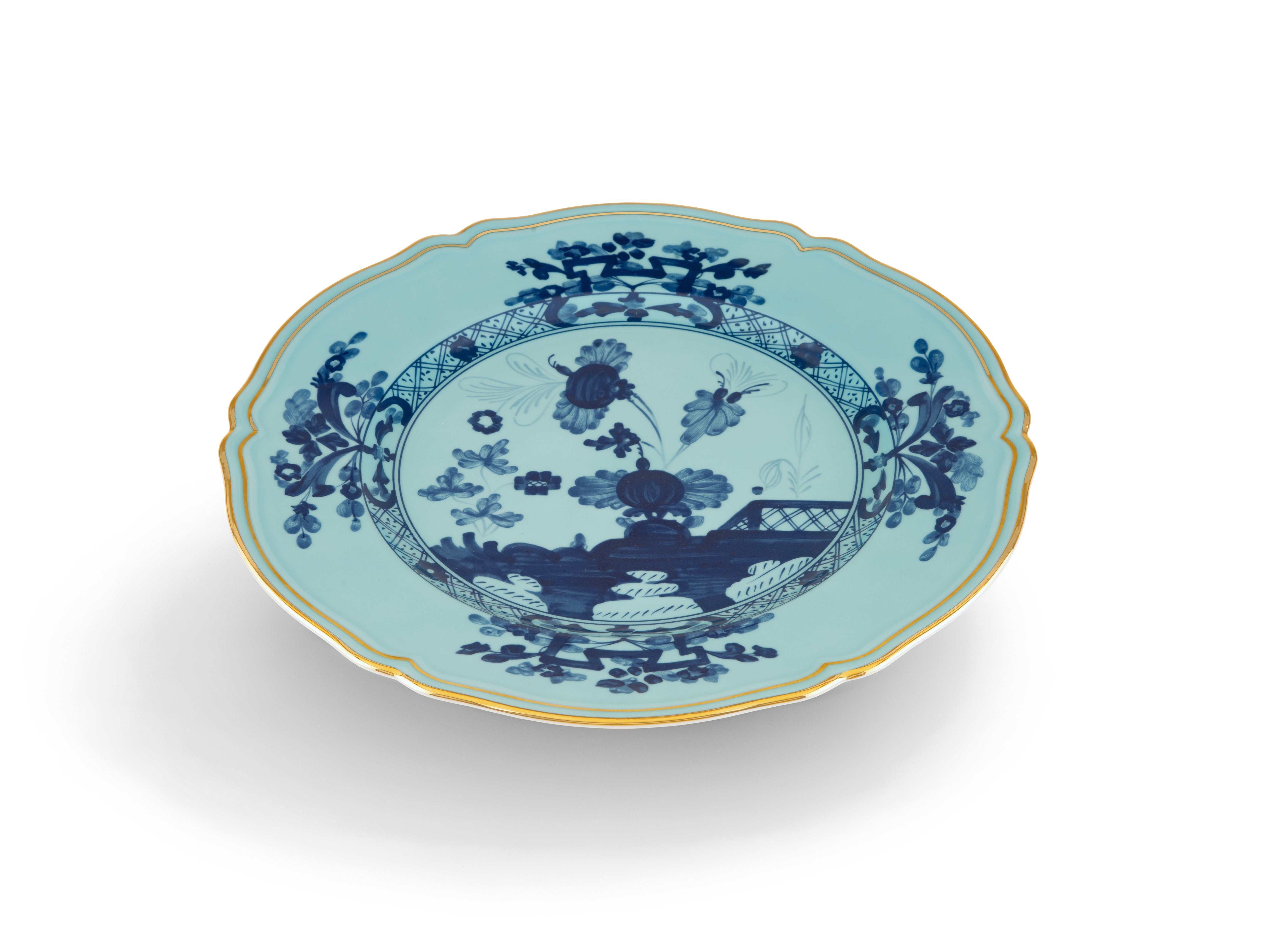 Elevate your dining experience with the exquisite Oriente Italiano Collection Porcelain Charger Plate, a masterpiece from Ginori 1735. This luxurious charger plate is meticulously crafted from fine white porcelain, offering a canvas for intricate artistry. The delicate floral ornamentation, hand-painted in pure gold, traces the classic lines of the Antico Doccia pattern, a signature of the esteemed Florentine Maison.