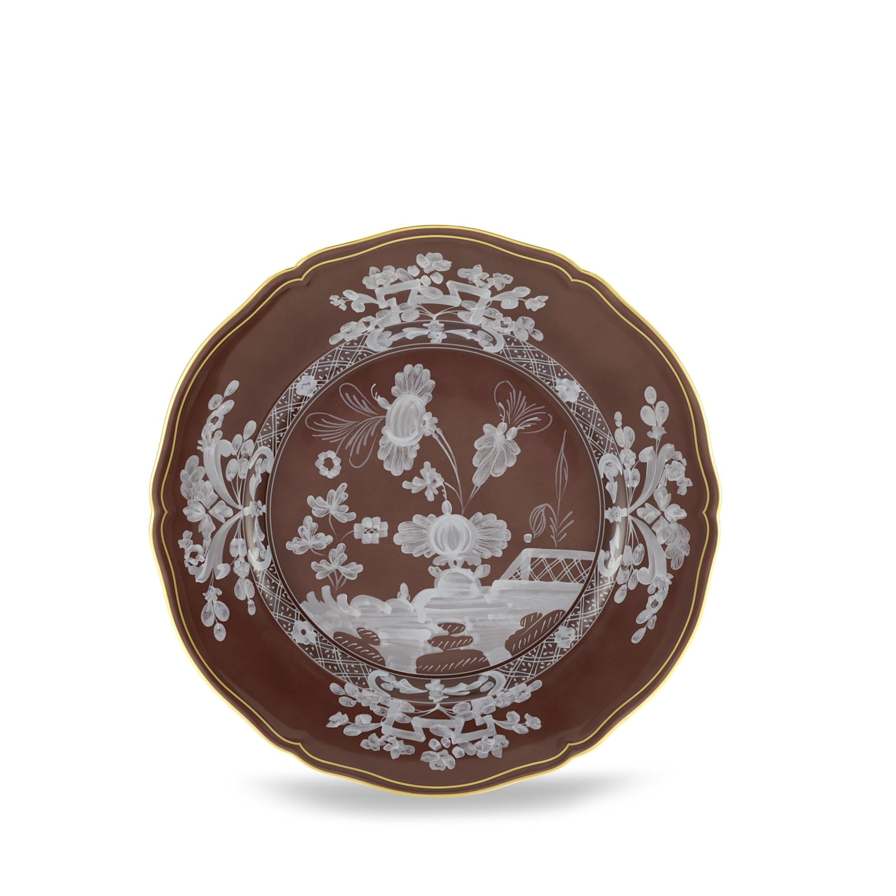 Elevate your dining experience with the exquisite Oriente Italiano Collection Porcelain CASTAGNA Charger Plate, a masterpiece from Ginori 1735. This luxurious charger plate is meticulously crafted from fine white porcelain, offering a canvas for intricate artistry. The delicate floral ornamentation, hand-painted in pure gold, traces the classic lines of the Antico Doccia pattern, a signature of the esteemed Florentine Maison.