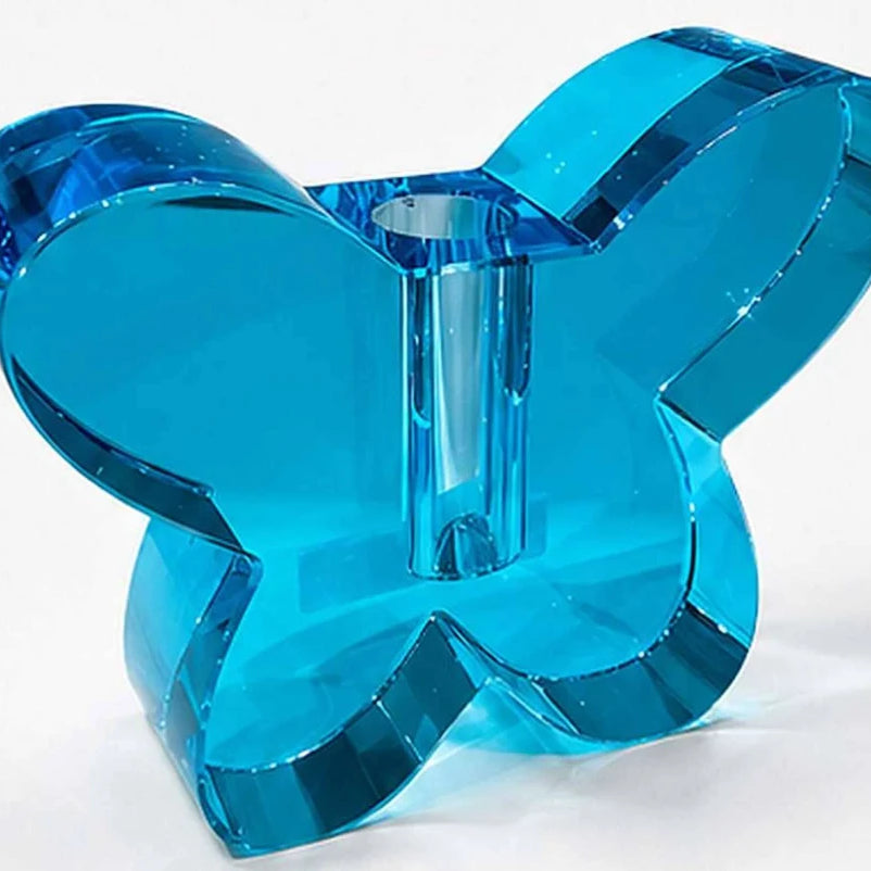 Blue butterfly-shaped candle holder on a white background