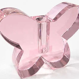 Pink butterfly-shaped object on a white background