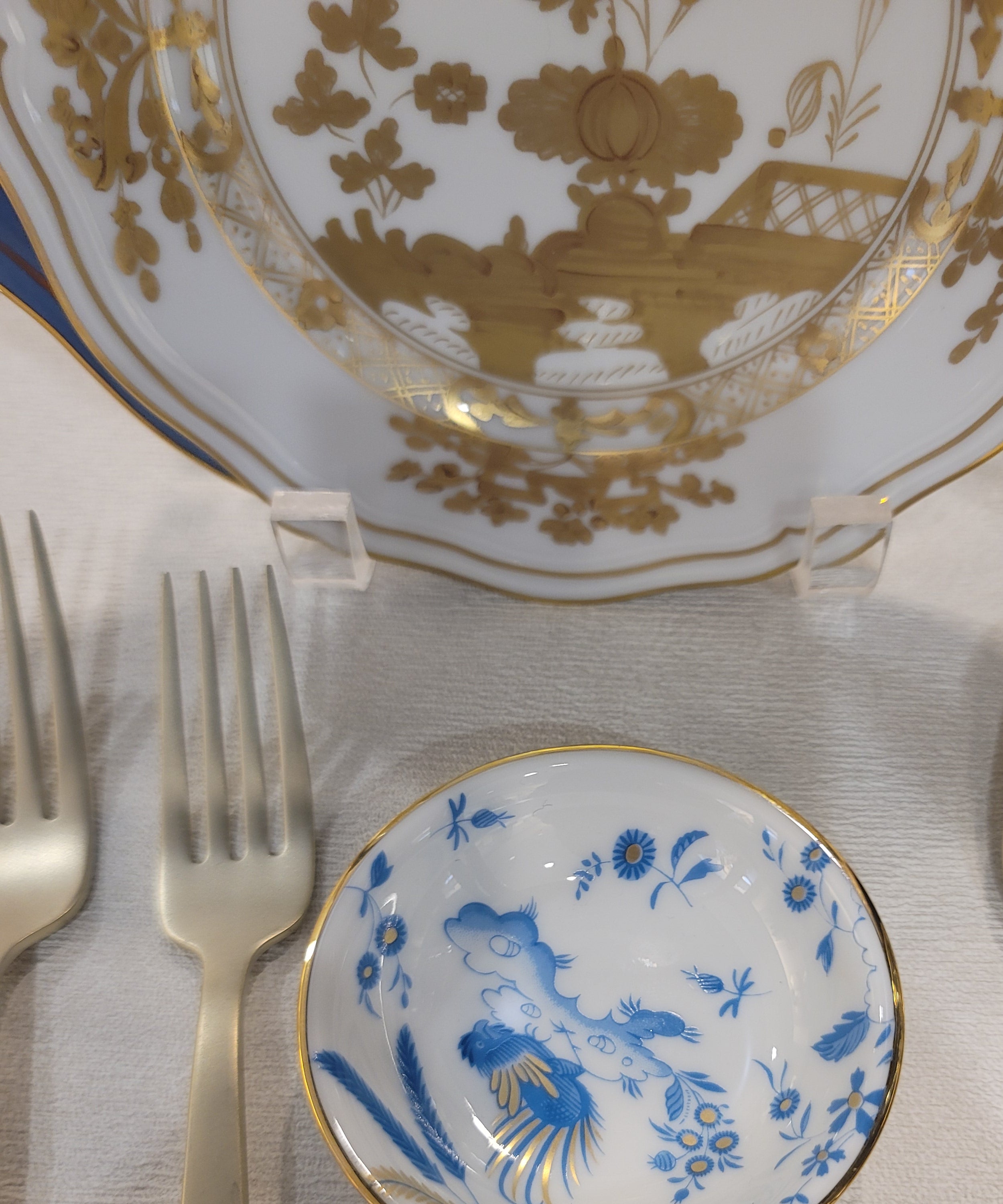 Set of gold and blue ceramic soy cup on a textured surface