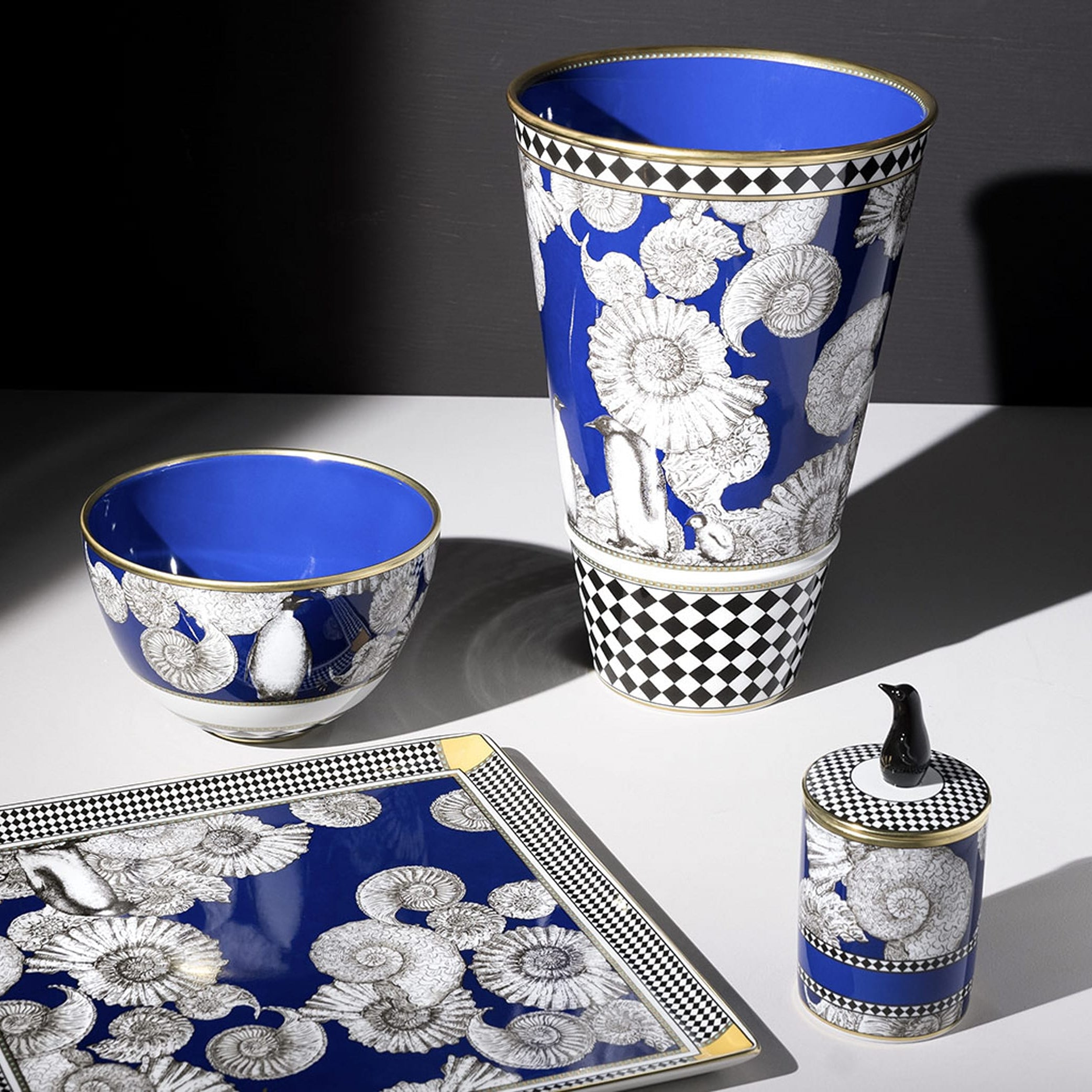 Penguin Vase: A blue and black vase with cone shells. Symbolizing love and loyalty, the Penguin design embodies grace and devotion. Its charming appearance adds a touch of affection to your decor, making it a perfect choice for commemorating special moments.