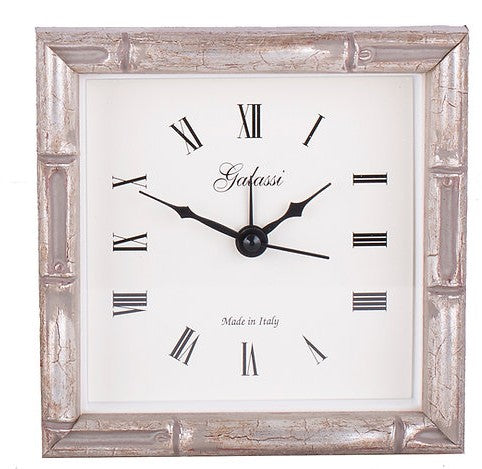 Square wall clock with metallic frame and Roman numeral markings, Galassi brand visible.