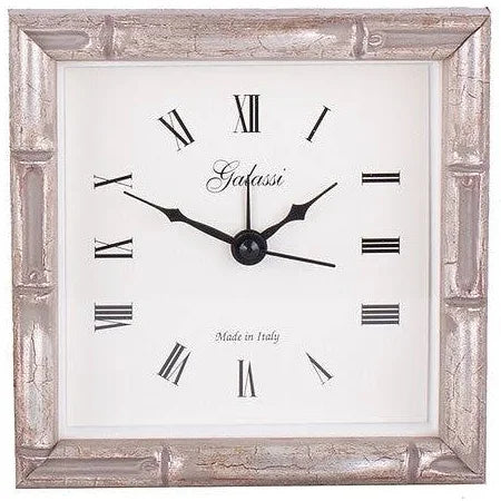 Decorative wall clock with metallic frame and Roman numeral markings, featuring the brand 'Grafasti'.