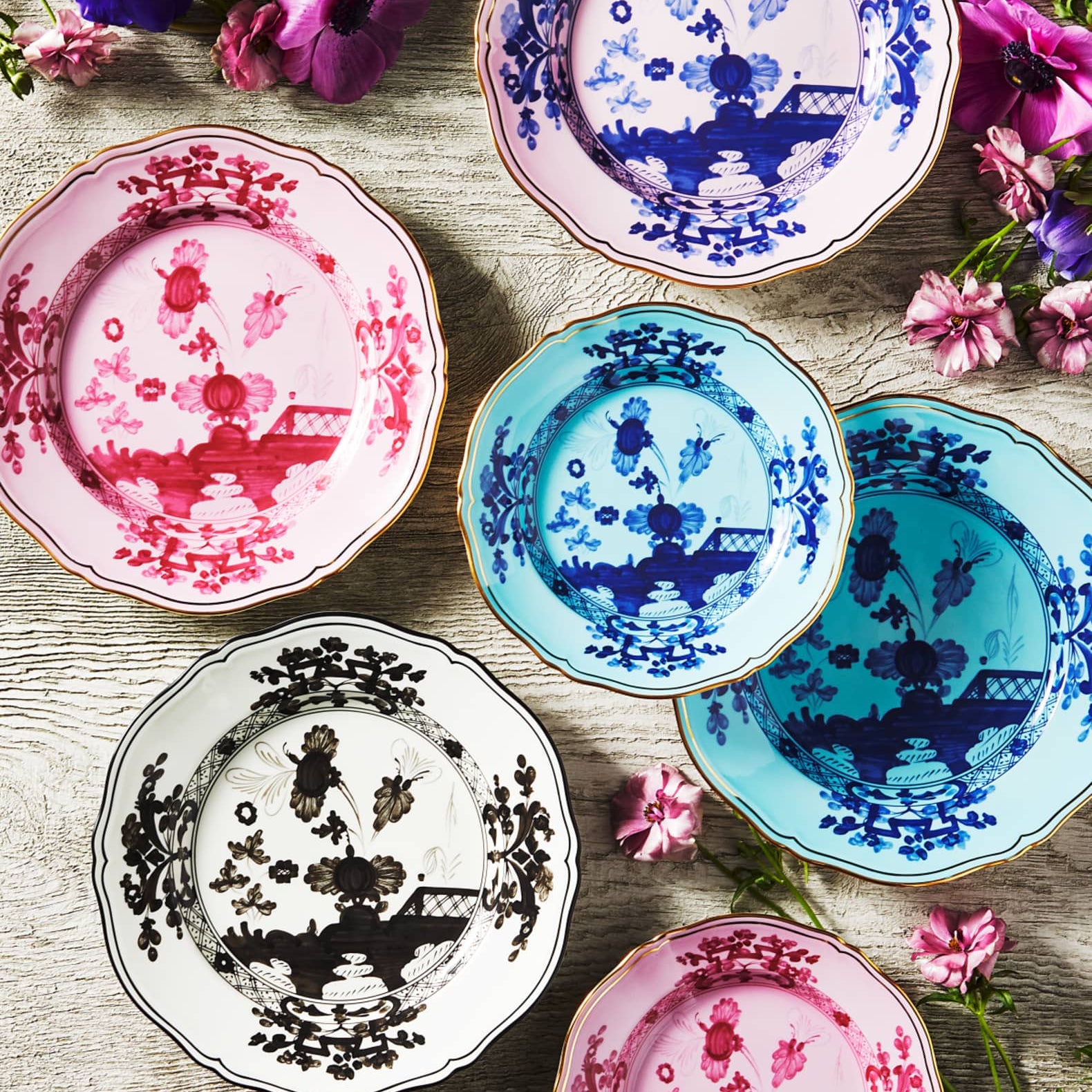 Porcelain Round Flat Platter from Oriente Italiano collection.Finished in a richer, partisan color palette of pink and red, the Porpora collection seemingly takes place at sunset with a warm garden scene of the Florentine “garofano” garden flower.