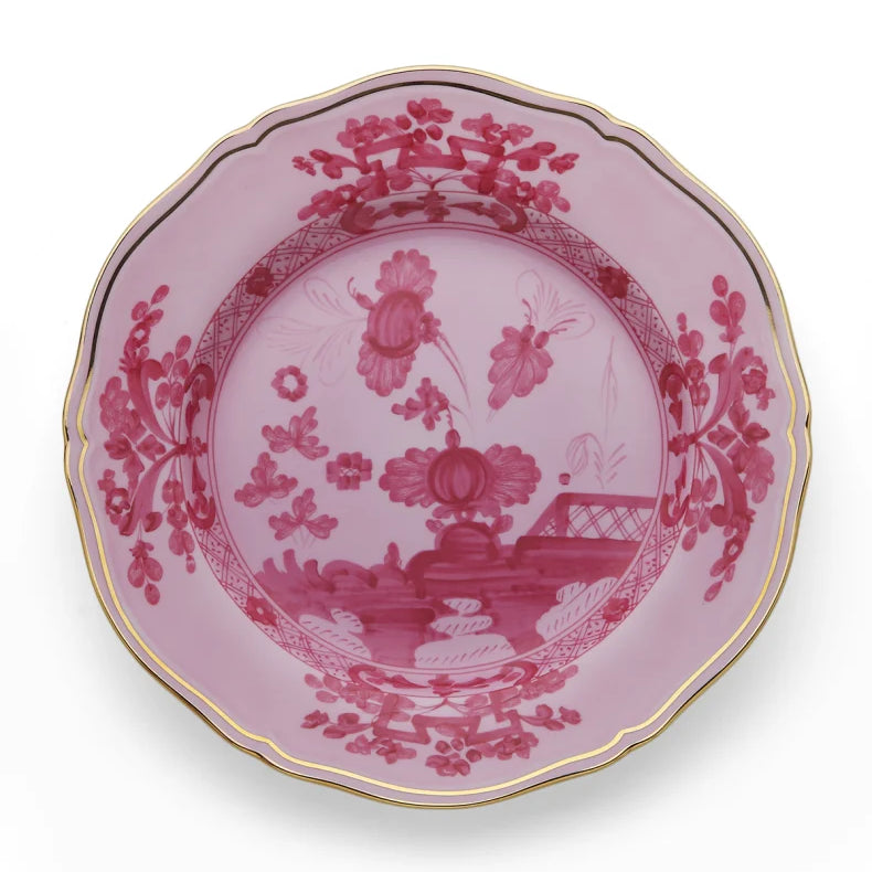 Porcelain Round Flat Platter from Oriente Italiano collection.Finished in a richer, partisan color palette of pink and red, the Porpora collection seemingly takes place at sunset with a warm garden scene of the Florentine “garofano” garden flower.