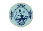 Elevate your dining experience with the exquisite Oriente Italiano Collection Porcelain Charger Plate, a masterpiece from Ginori 1735. This luxurious charger plate is meticulously crafted from fine white porcelain, offering a canvas for intricate artistry. The delicate floral ornamentation, hand-painted in pure gold, traces the classic lines of the Antico Doccia pattern, a signature of the esteemed Florentine Maison.  