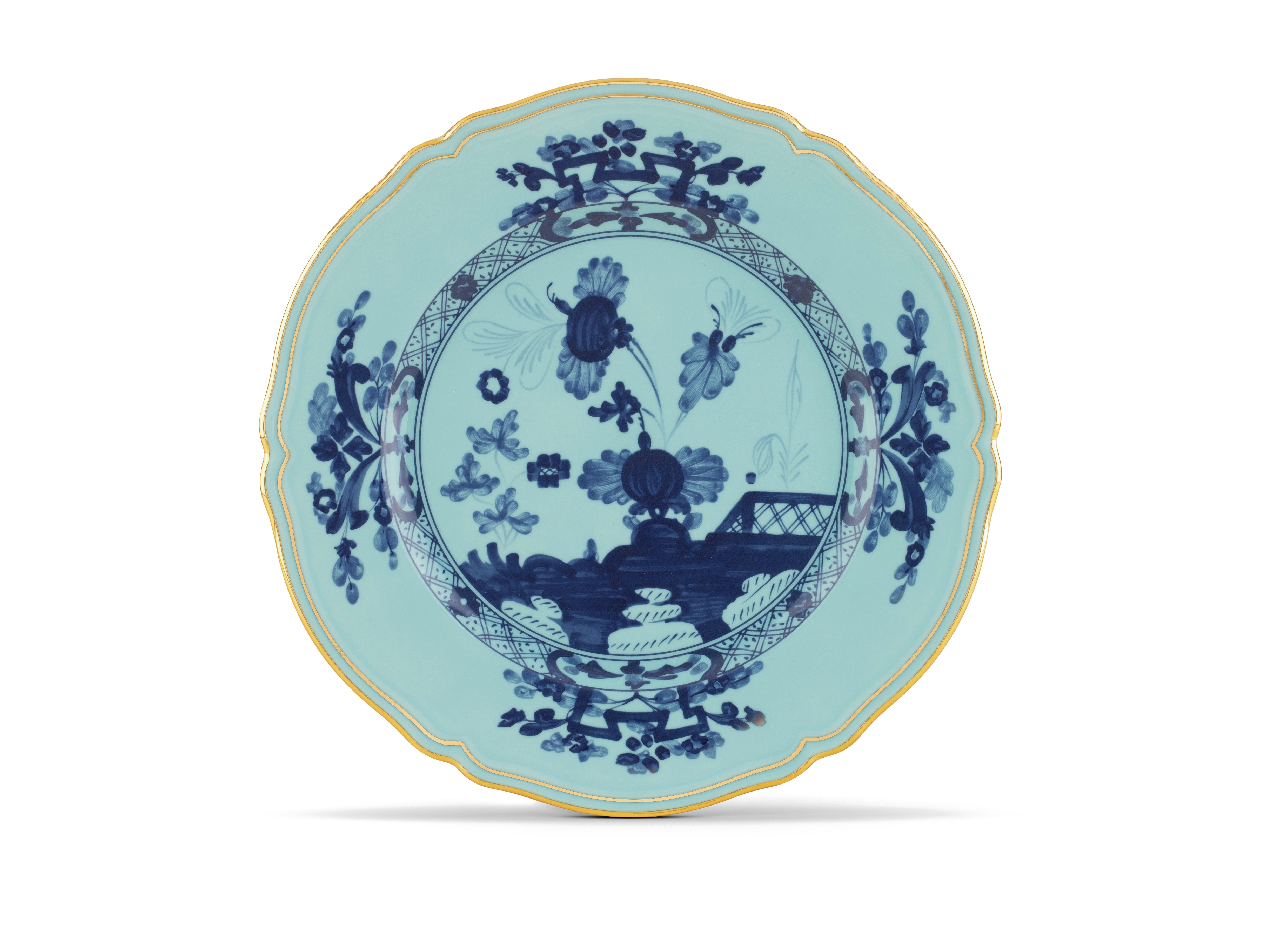 Elevate your dining experience with the exquisite Oriente Italiano Collection Porcelain Charger Plate, a masterpiece from Ginori 1735. This luxurious charger plate is meticulously crafted from fine white porcelain, offering a canvas for intricate artistry. The delicate floral ornamentation, hand-painted in pure gold, traces the classic lines of the Antico Doccia pattern, a signature of the esteemed Florentine Maison.  