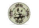Elevate your dining experience with the exquisite Oriente Italiano Collection Porcelain BARIO Charger Plate, a masterpiece from Ginori 1735. This luxurious charger plate is meticulously crafted from fine white porcelain, offering a canvas for intricate artistry. The delicate floral ornamentation, hand-painted in pure gold, traces the classic lines of the Antico Doccia pattern, a signature of the esteemed Florentine Maison.