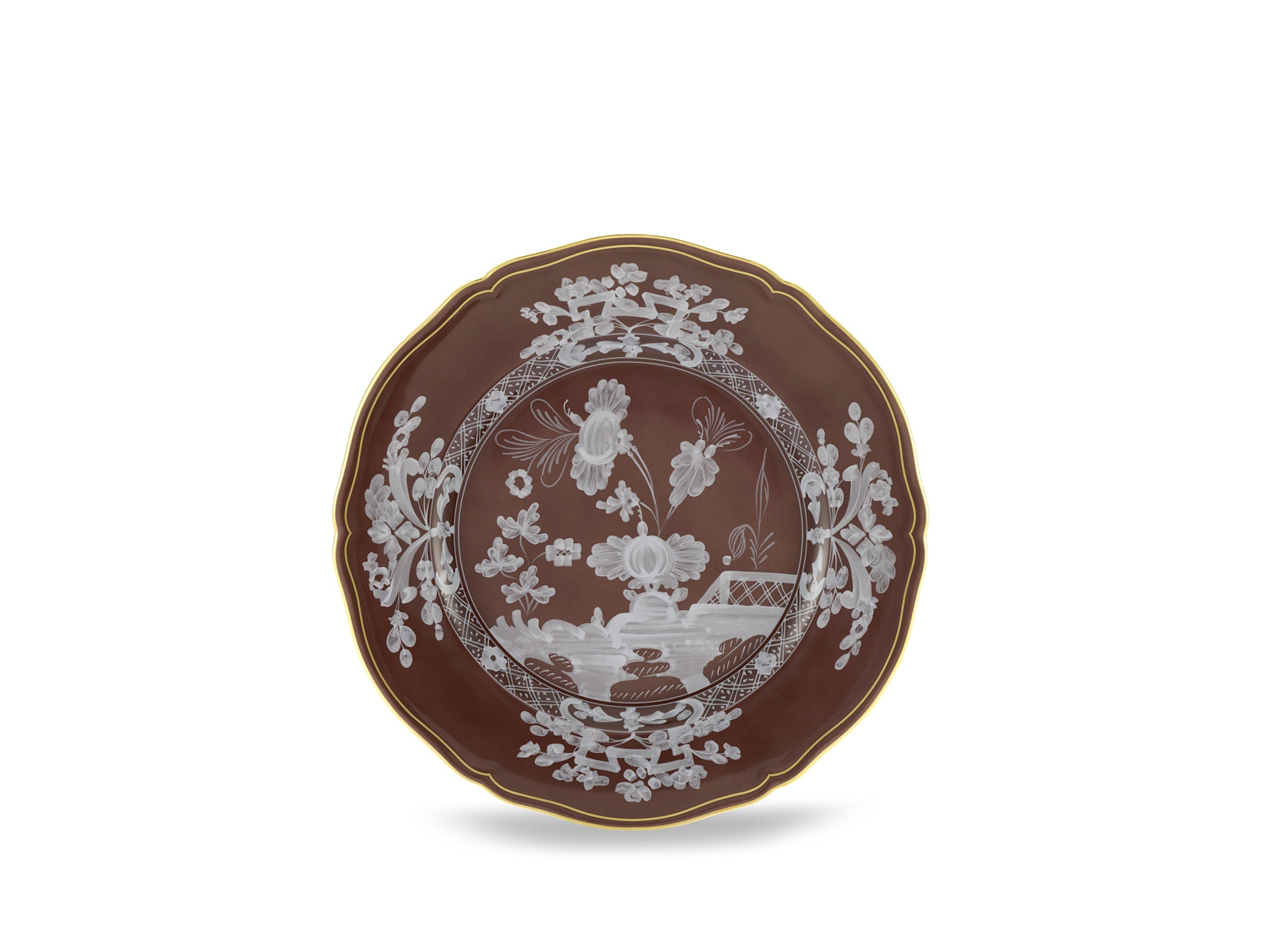 Elevate your dining experience with the exquisite Oriente Italiano Collection Porcelain  CASTAGNA Charger Plate, a masterpiece from Ginori 1735. This luxurious charger plate is meticulously crafted from fine white porcelain, offering a canvas for intricate artistry. The delicate floral ornamentation, hand-painted in pure gold, traces the classic lines of the Antico Doccia pattern, a signature of the esteemed Florentine Maison.