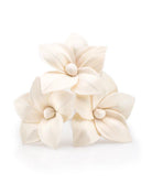 Cream-colored floral hair clips on a white background