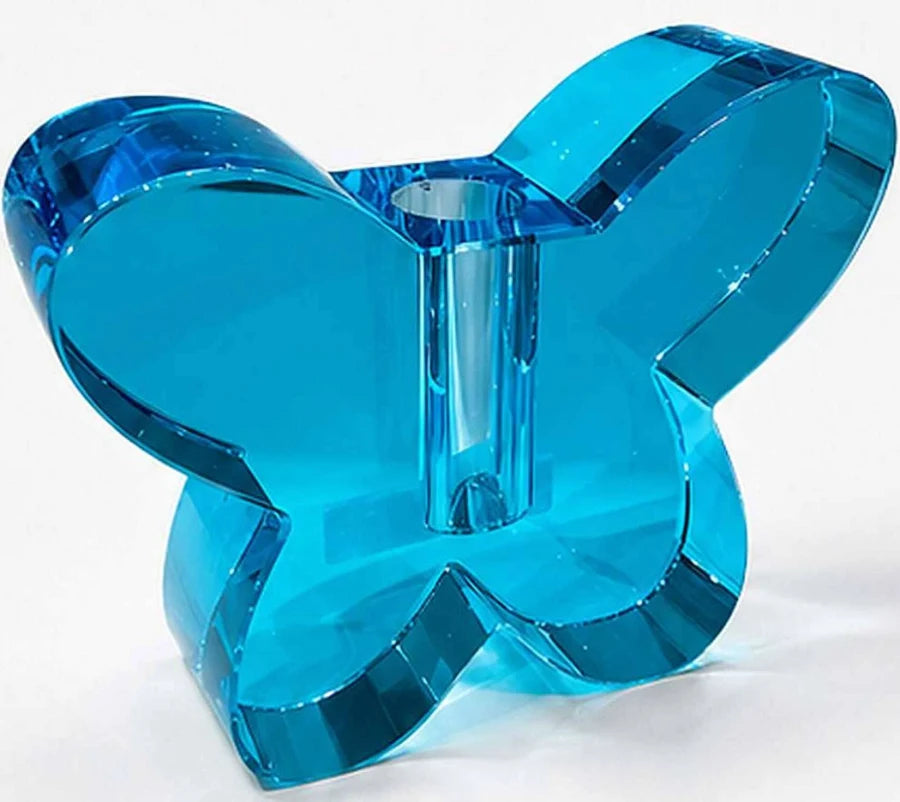 Blue butterfly-shaped candle holder on a white background