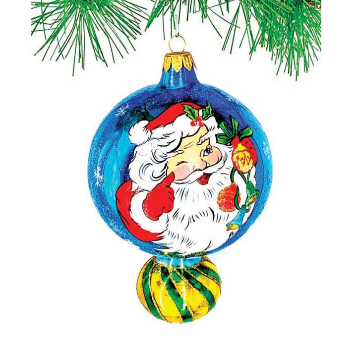 Winter Winkler Is A Classic 6.00 Inch Polish Double Ball Drop Ornament Of Blue With A Hand-Painted Classic Winking Santa With A Glittered Beard. Hand-Painted Glittered Snowflakes Compliment The Blue Background.