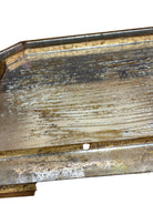 Close-up of a decorative wooden surface with visible wear and tear