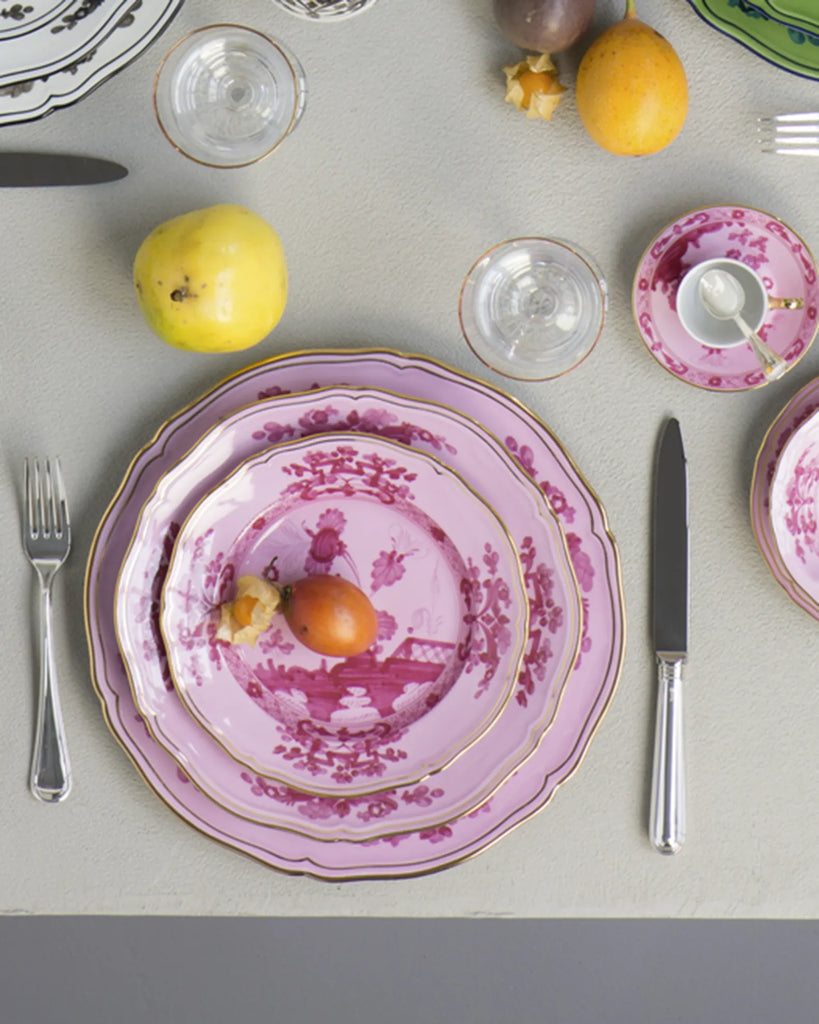 Porcelain Round Flat Platter from Oriente Italiano collection.Finished in a richer, partisan color palette of pink and red, the Porpora collection seemingly takes place at sunset with a warm garden scene of the Florentine “garofano” garden flower.