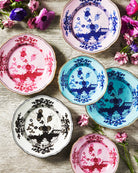 Porcelain Round Flat Platter from Oriente Italiano collection.Finished in a richer, partisan color palette of pink and red, the Porpora collection seemingly takes place at sunset with a warm garden scene of the Florentine “garofano” garden flower.
