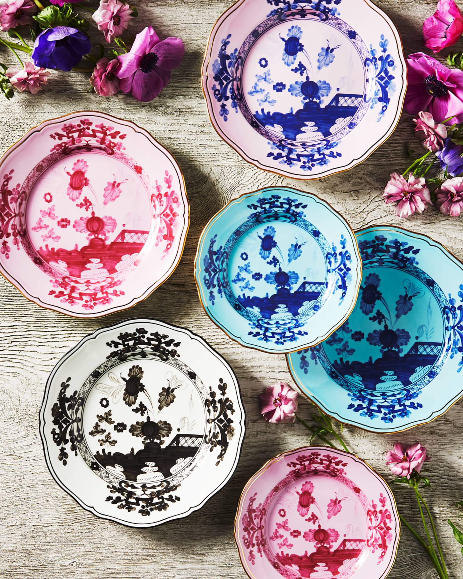 Porcelain Round Flat Platter from Oriente Italiano collection.Finished in a richer, partisan color palette of pink and red, the Porpora collection seemingly takes place at sunset with a warm garden scene of the Florentine “garofano” garden flower.