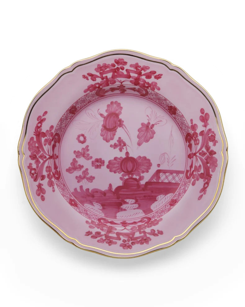 Porcelain Round Flat Platter from Oriente Italiano collection.Finished in a richer, partisan color palette of pink and red, the Porpora collection seemingly takes place at sunset with a warm garden scene of the Florentine “garofano” garden flower. 